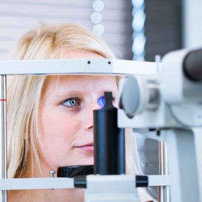 Woman selecting glasses after a vision insurance consultation in Folsom, CA